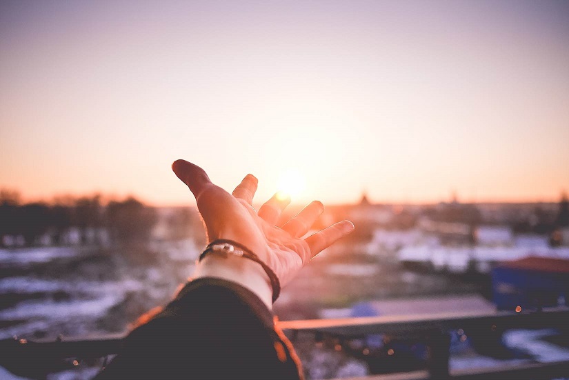 Reaching out to the sun setting during Daylight Saving Time